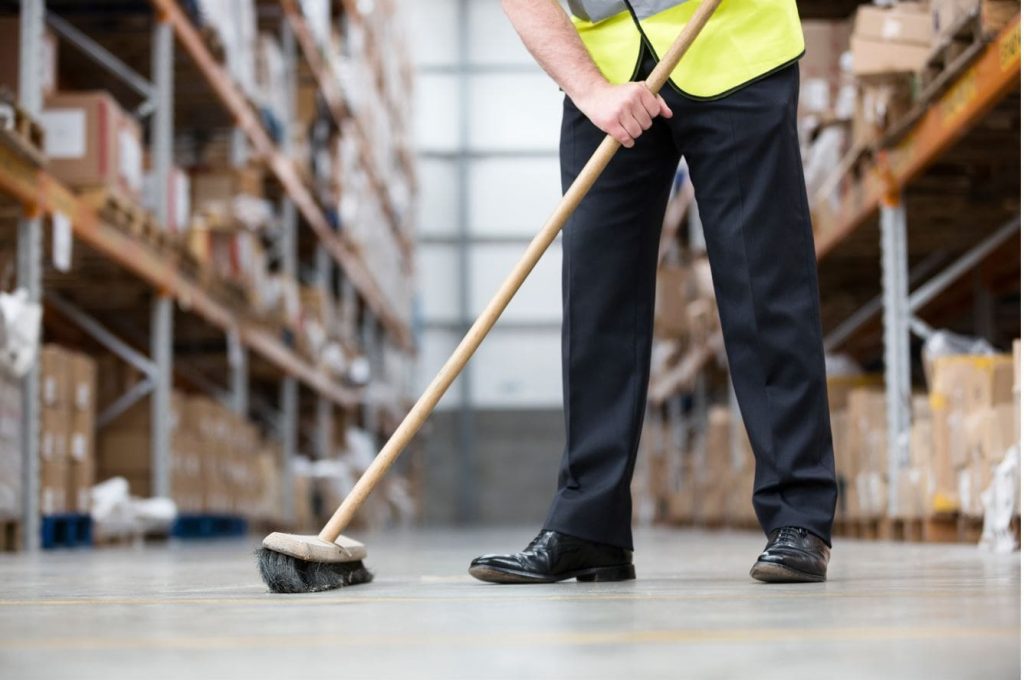 Cleaner rubbing the warehouse hard floor