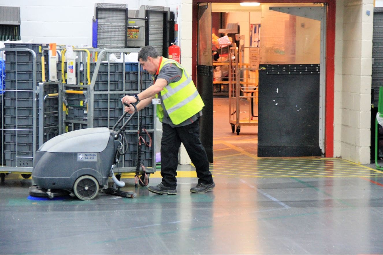 Scrubbing warehouse floor keeps from away from dirt's & grease